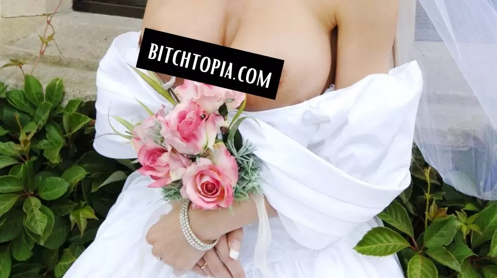 woman showing off her big breasts in her wedding dress